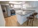 Modern kitchen featuring stainless steel appliances, granite countertops, white cabinets, and stylish breakfast bar seating at 10729 Drummond Rd, Tampa, FL 33615