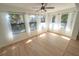 Bright sunroom featuring wood floors, white walls, and large windows at 10729 Drummond Rd, Tampa, FL 33615