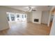 Open living room with wood floors, a fireplace, and a sunroom at 10729 Drummond Rd, Tampa, FL 33615