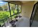 Relaxing balcony with two chairs offering serene views of the lush green lawn and mature trees at 110 Lakeside Ct # 110, Oldsmar, FL 34677