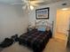 Bedroom featuring comfortable bed, ceiling fan, closet, and dresser for a relaxing atmosphere and practical storage at 110 Lakeside Ct # 110, Oldsmar, FL 34677