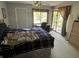 Bedroom featuring a comfortable bed, a desk, and a patio, providing comfort and convenience at 110 Lakeside Ct # 110, Oldsmar, FL 34677