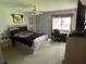 Cozy bedroom with a ceiling fan, comfortable bed, and desk area near the window, perfect for work or relaxation at 110 Lakeside Ct # 110, Oldsmar, FL 34677