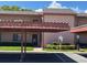 Inviting condo featuring covered parking and manicured landscaping around the building at 110 Lakeside Ct # 110, Oldsmar, FL 34677