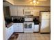 Bright kitchen featuring white cabinetry, a microwave, and a tiled floor at 110 Lakeside Ct # 110, Oldsmar, FL 34677