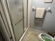 Bathroom featuring a shower with glass doors and neutral color scheme, providing comfort and convenience at 110 Lakeside Ct # 110, Oldsmar, FL 34677