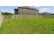 A shot of the green backyard, featuring well-maintained grass and a white privacy fence at 11002 Sundrift Dr, Tampa, FL 33647