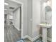 Bathroom featuring a pedestal sink with a modern faucet and tiled floor at 11002 Sundrift Dr, Tampa, FL 33647
