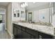 Bathroom featuring a vanity with granite countertop and dark cabinets at 11002 Sundrift Dr, Tampa, FL 33647