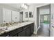 Bathroom featuring a vanity with granite countertop and dark cabinets at 11002 Sundrift Dr, Tampa, FL 33647