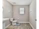 Bathroom featuring tiled floors, sink, toilet, and small window at 11002 Sundrift Dr, Tampa, FL 33647