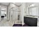 Modern bathroom featuring a glass shower with chrome trim and a granite topped vanity with black cabinets at 11002 Sundrift Dr, Tampa, FL 33647