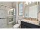 Bathroom featuring a glass shower, toilet, and a dark cabinet vanity with a granite countertop at 11002 Sundrift Dr, Tampa, FL 33647