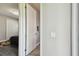 View from hallway through a doorway to a bedroom with a ceiling fan and a large closet at 11002 Sundrift Dr, Tampa, FL 33647