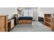 Bedroom showcasing wood-stained bed with storage, a gray laminate floor and a mini fridge at 11002 Sundrift Dr, Tampa, FL 33647