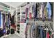 Spacious walk-in closet with custom shelving, hanging racks, and drawers for optimal organization at 11002 Sundrift Dr, Tampa, FL 33647