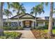 Inviting entrance to the clubhouse, framed by lush landscaping and stately palm trees at 11002 Sundrift Dr, Tampa, FL 33647