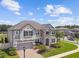 Stately two-story home featuring stone accents, a manicured front yard, and a welcoming entrance at 11002 Sundrift Dr, Tampa, FL 33647