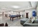 Game room showcasing a pool table, kitchenette, seating area, and stairs at 11002 Sundrift Dr, Tampa, FL 33647