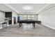 Spacious game room featuring a pool table, kitchenette, and comfortable seating area at 11002 Sundrift Dr, Tampa, FL 33647
