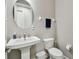 Charming half bathroom with pedestal sink and modern fixtures at 11002 Sundrift Dr, Tampa, FL 33647