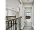 Hallway showcasing a decorative chandelier and view into the primary bedroom at 11002 Sundrift Dr, Tampa, FL 33647