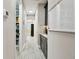 Hallway with a pantry, coffee bar, and white board at 11002 Sundrift Dr, Tampa, FL 33647