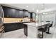 Modern kitchen features granite countertops, black cabinetry, and stainless steel appliances at 11002 Sundrift Dr, Tampa, FL 33647