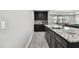 Features modern, dark cabinets, granite counters, and stainless steel appliances at 11002 Sundrift Dr, Tampa, FL 33647