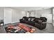 The living room features a movie theater theme with tiered leather seats and cinema rug at 11002 Sundrift Dr, Tampa, FL 33647
