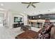 Open-concept living room features a modern kitchen with stainless steel appliances at 11002 Sundrift Dr, Tampa, FL 33647