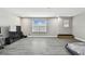Living room offering laminate floors, white walls, and large window with blinds at 11002 Sundrift Dr, Tampa, FL 33647