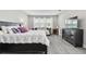 Spacious main bedroom with plush bedding, sitting area, and hardwood floors at 11002 Sundrift Dr, Tampa, FL 33647
