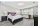 Bright and airy main bedroom featuring modern decor and ample natural light at 11002 Sundrift Dr, Tampa, FL 33647