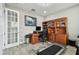 A home office with a desk, chair, and built-in shelves, offering functionality at 11002 Sundrift Dr, Tampa, FL 33647