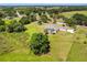 Aerial view of the property with a screened pool, long driveway, and lush landscaping at 1109 Colson Rd, Plant City, FL 33567
