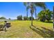 Expansive backyard with lush lawn, mature trees, and clear blue sky offers ample space and privacy at 1109 Colson Rd, Plant City, FL 33567