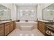 Elegant bathroom with a central tub and dual vanities at 1109 Colson Rd, Plant City, FL 33567