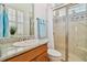 Bright bathroom featuring granite counters, a glass-enclosed shower, and charming blue accents at 1109 Colson Rd, Plant City, FL 33567