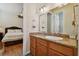 Bathroom with granite countertop vanity, large mirror, and view of the bedroom at 1109 Colson Rd, Plant City, FL 33567