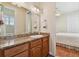 Bathroom with granite countertop vanity, large mirror, and view of the bedroom at 1109 Colson Rd, Plant City, FL 33567