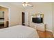 Bright bedroom featuring wood floors, ceiling fan, and an ensuite bathroom at 1109 Colson Rd, Plant City, FL 33567