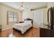 Cozy bedroom with hardwood floors, ceiling fan, and ample natural light from the window at 1109 Colson Rd, Plant City, FL 33567