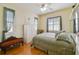 Well-lit bedroom with hardwood floors, seating area, and natural light at 1109 Colson Rd, Plant City, FL 33567