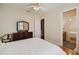 Bright bedroom featuring wood floors, ceiling fan, and an ensuite bathroom at 1109 Colson Rd, Plant City, FL 33567