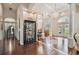 Open concept living space featuring hardwood floors, columns, elegant furnishings, and views of the dining area at 1109 Colson Rd, Plant City, FL 33567