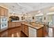 Open kitchen with island, granite counters, wooden cabinets, and stainless steel appliances at 1109 Colson Rd, Plant City, FL 33567