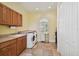 Spacious laundry room with abundant cabinet space, modern washer and dryer, and a well-lit design at 1109 Colson Rd, Plant City, FL 33567