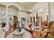 A spacious living room with columns, hardwood floors, marble accents, and chandelier lighting at 1109 Colson Rd, Plant City, FL 33567