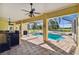 Covered outdoor pool area with a grill and spacious seating, perfect for entertaining guests at 1109 Colson Rd, Plant City, FL 33567